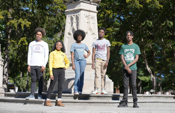  Students from exam high schools posing in school shorts in front of a fountain