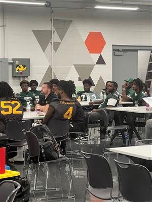 football players listening to coaches