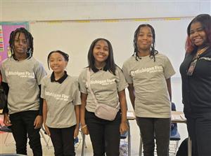1 boy and 3 girls in Michigan First shirts with an adult female 