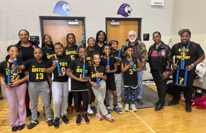  A group of girls and adults posing for a picture