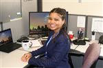 Naomi Hill sits at desk 