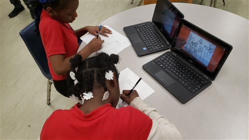 Students looking at computer screen 