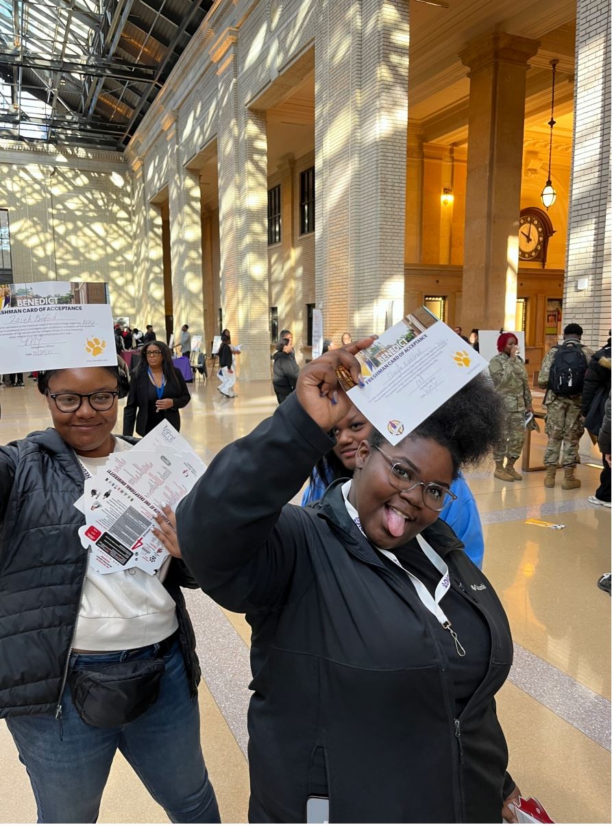 Students posing with acceptance letters 
