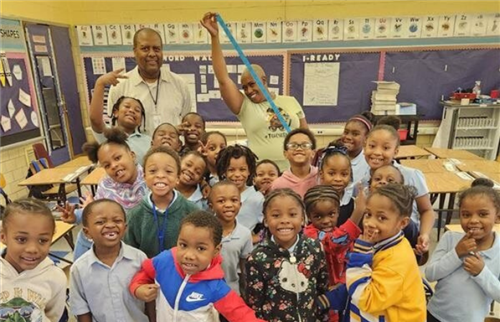 students in the classroom posing with staff