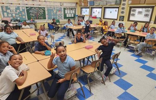 students sitting a desks in classroom