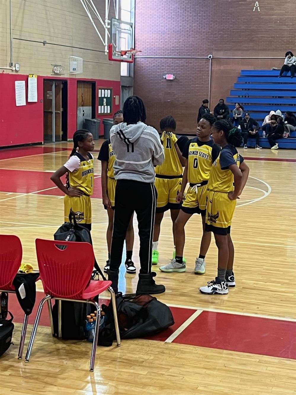  a group of female basketball players with their coach