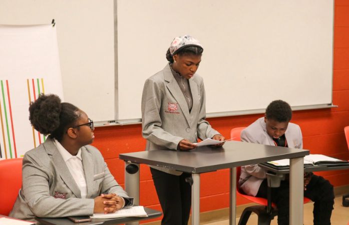  Student stand at a podium 