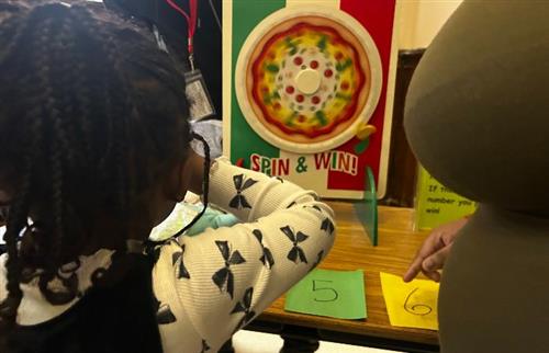 student spinning a wheel for prizes