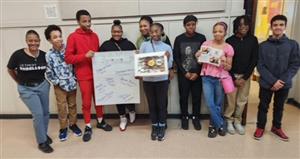  Students standing with a sign