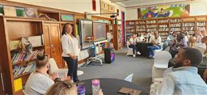 Ms. Clayton speaks with staff