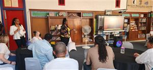 Assistant Superintendent Ms. Michell speaks with staff