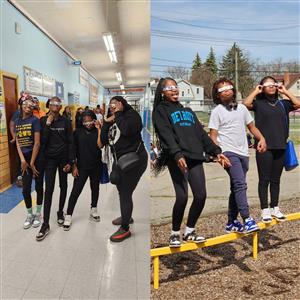 Students standing with glasses on and looking up at the sky