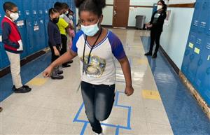 Male Student playing Hopscotch