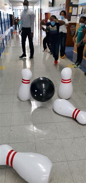 Teacher and students play bowling