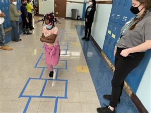 Female Student playing Hopscotch