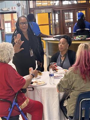 Principal Clayton give hig five to teacher