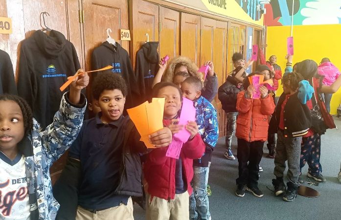  Students hold PAWS bucks