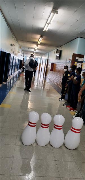 Teacher and students play bowling