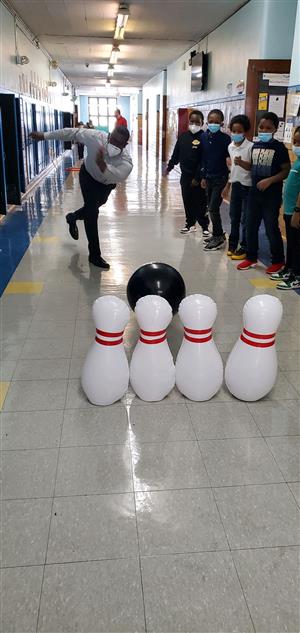 Teacher and students play bowling