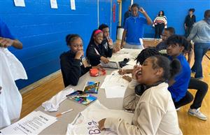 group of students laughing and working on project