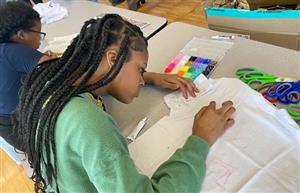  Student drawing on a shirt