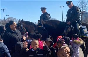 students and horses with police officers