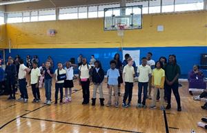  students at a school posing for picture in gym