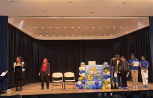  Staff on stage passing out certificates for students