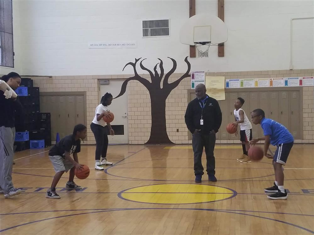  basketball players practicing in gym