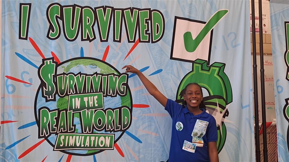  Student pointing to I Survived sign