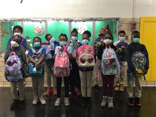 Students holding their book bags
