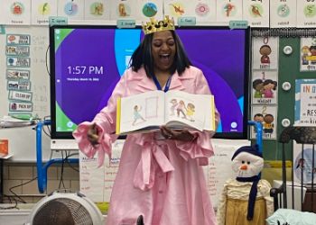 parent dressed as a princess reading to students