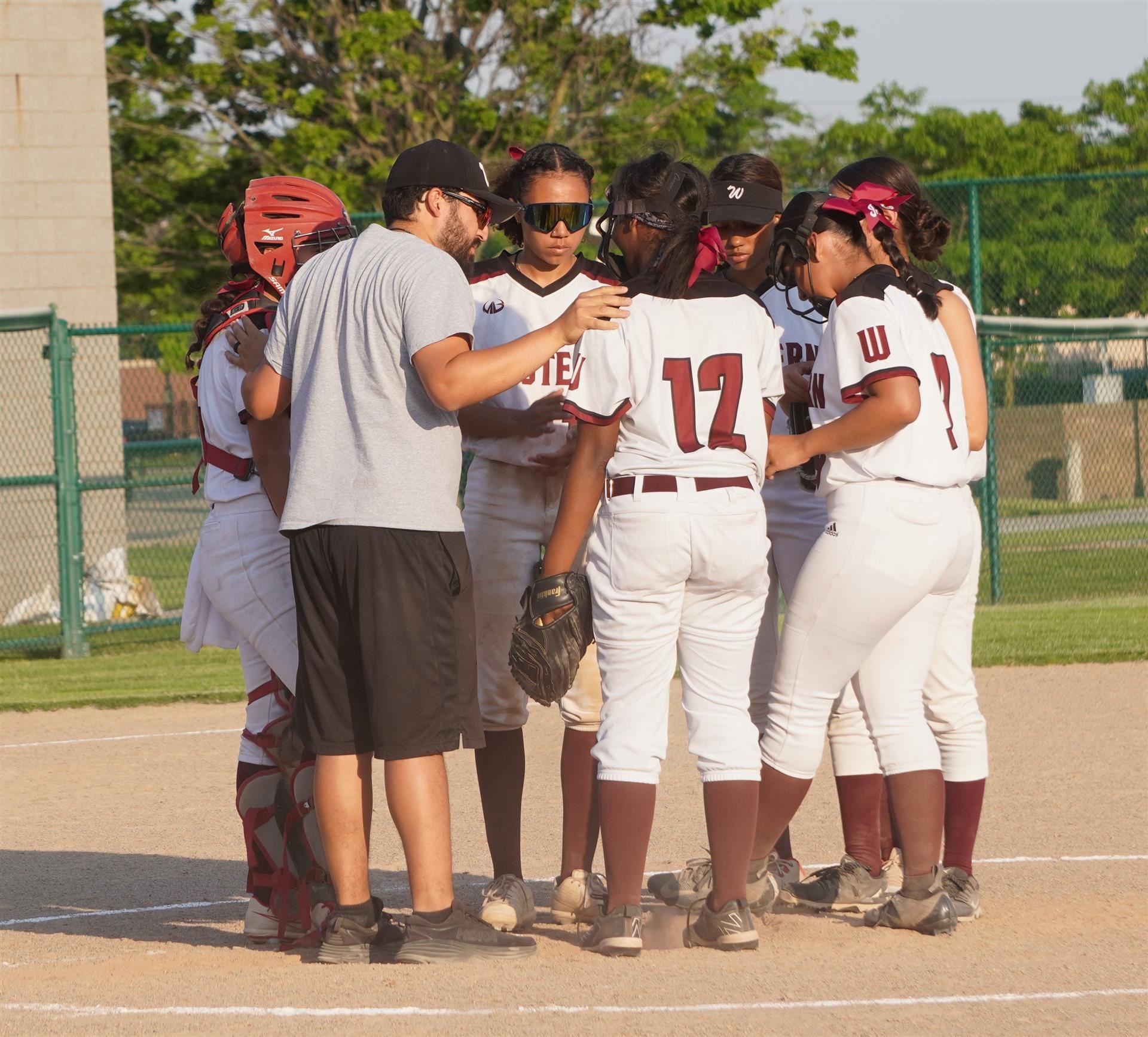 western coach huddling with players 