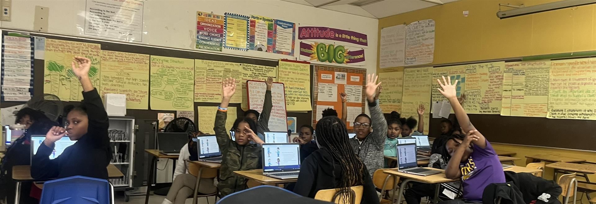  Students in classroom in front of laptops 