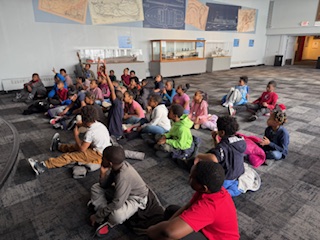  students sitting on carpet 