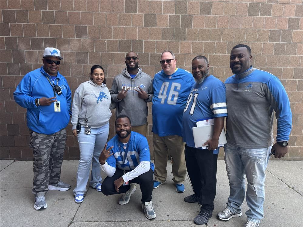 five males and one female dressed in Detroit Lions gear.