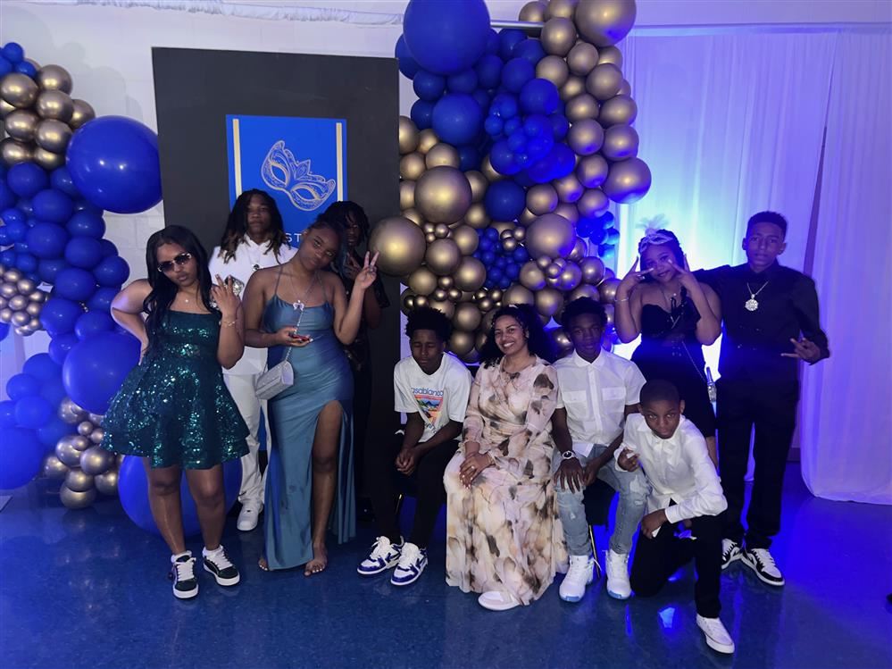  A group of individuals posing in front of balloons.
