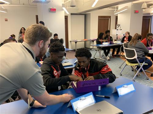 Students working on project with volunteer. 