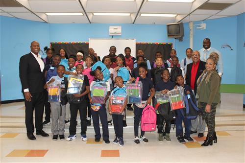 Carstens students, administration, State Rep. Tate and Robert Jones pose with backpacks and supplies. 