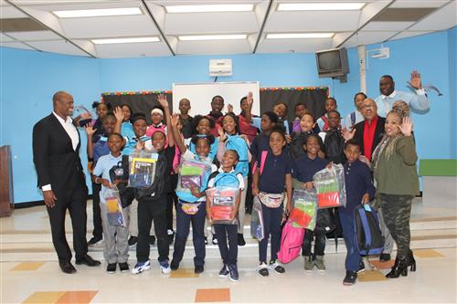 Carstens students, administration State Rep. Tate and Robert Jones pose with backpacks and supplies. 