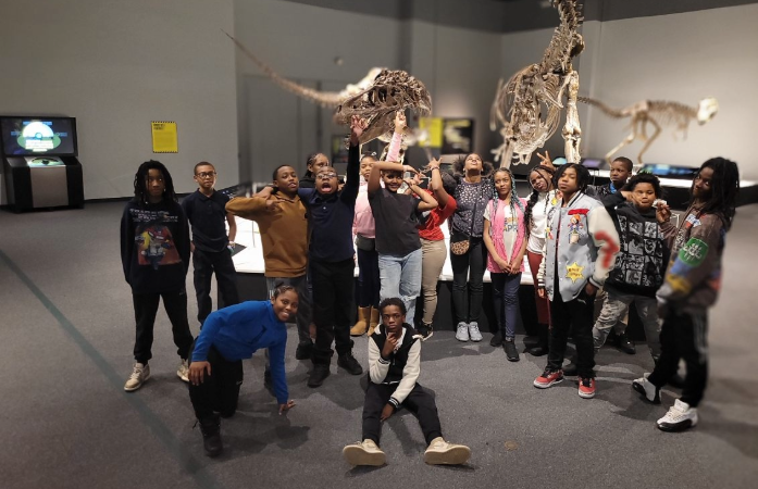  students posing in front of a reptile