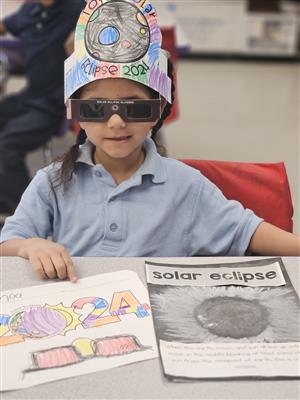 Student with solar eclipse activities
