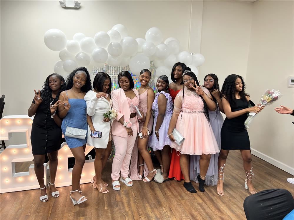  Females standing in front of Balloons