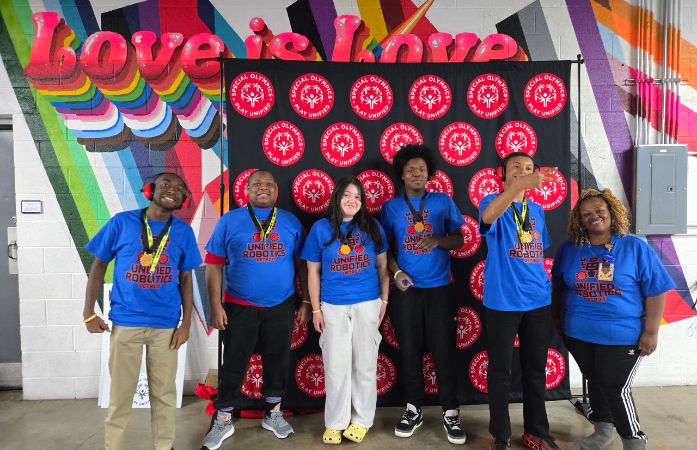  Students and teacher taking a photograph for the award.