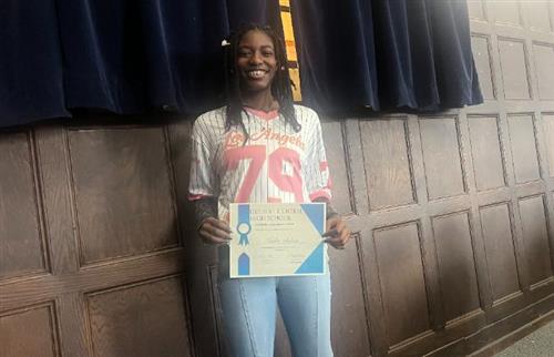  A girl smiling holding a paper