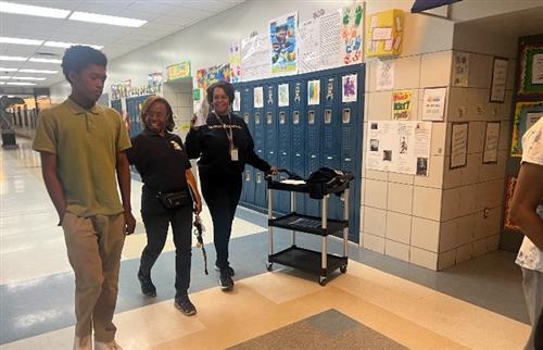  a boy walking with 2 ladies in the building