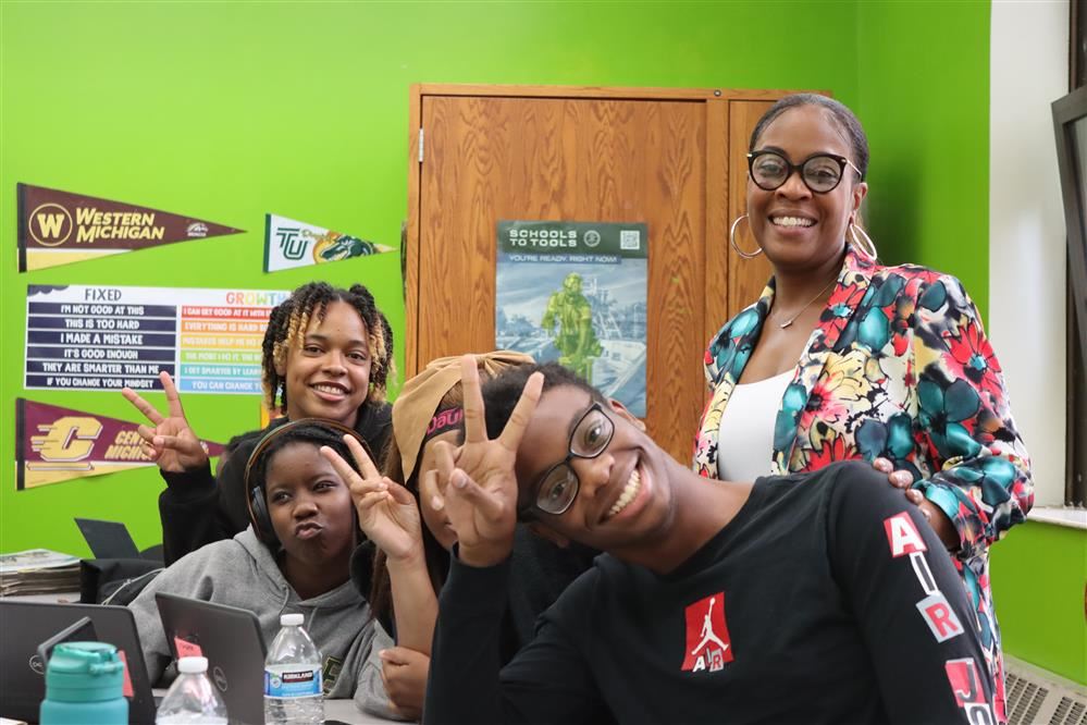 a female with students laughing in class.