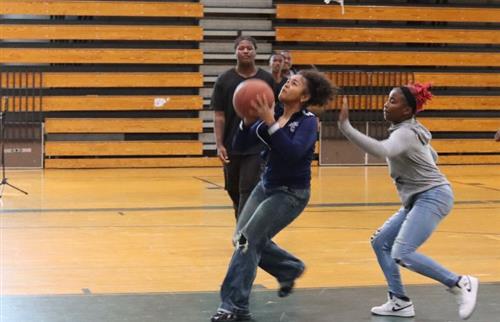 Two girls playing basketball
