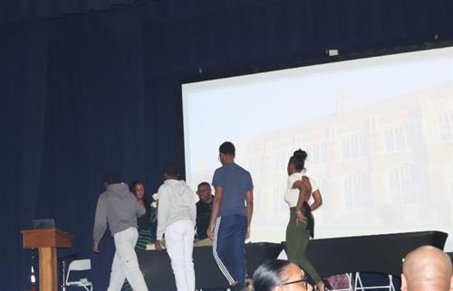 3 boys and 1 girl walking on the stage