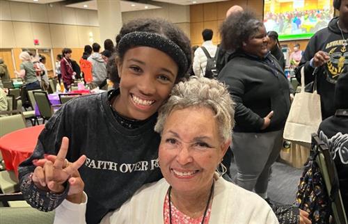 Student taking a picture with one of the presenters.